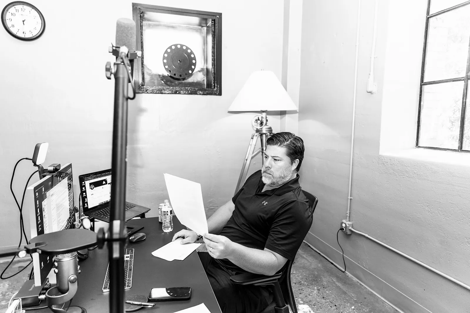 A Stealth leader reviewing a report at a desk in window light